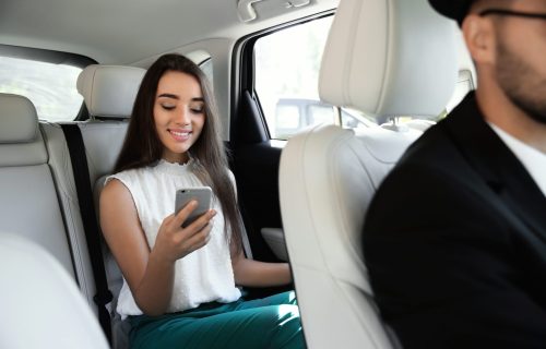 Young,Businesswoman,With,Driver,In,Luxury,Car.,Chauffeur,Service