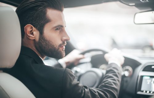 Businessman,In,Car.,Rear,View,Of,Young,Handsome,Man,Looking